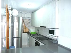 a kitchen with a sink and a refrigerator at Playamar in Alcossebre