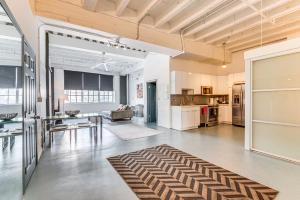 an open living room with a table and a kitchen at Downtown Los Angeles Condo with Rooftop Pool Access in Los Angeles