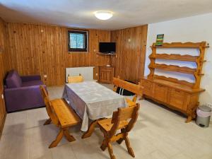 a living room with a table and a purple couch at Villa Kučan in Porat
