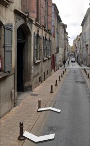 eine leere Straße mit einem weißen Pfeil auf der Straße in der Unterkunft Bulles de bonheur - Carcassonne in Carcassonne