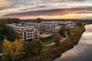 an aerial view of an apartment complex next to a river at STAR Apartament & Spa Dziwnów in Dziwnów