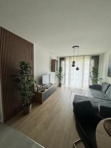 a living room with a couch and a table at STAR Apartament & Spa Dziwnów in Dziwnów