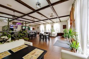 a restaurant with tables and chairs in a room at Marton Pashkovskiy Krasnodar in Krasnodar