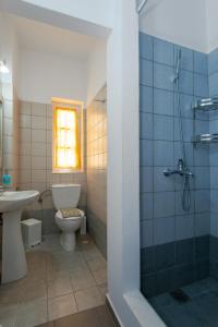 a bathroom with a toilet and a sink and a shower at Mare Nostrum Studios in Kamarai