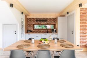a kitchen with a wooden table with a bowl of fruit at Leśna Przystań Gorce in Nowy Targ