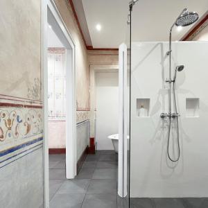 a bathroom with a shower stall and a toilet at Senhora da Praça in Gavião