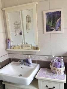 a bathroom with a sink and a mirror at House Lavanda in Njivice +44 photos