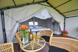 a table in a tent with a bed at KempingZator Glamping in Zator