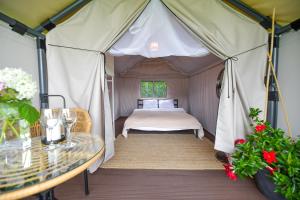 a bedroom in a tent with a bed and a table at KempingZator Glamping in Zator +87 photos