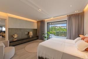 a bedroom with a large bed and a large window at The Shore 2 luxury beach front condo in Willemstad +50 photos