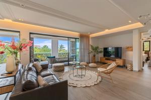 a living room with a couch and a tv at The Shore 2 luxury beach front condo in Willemstad