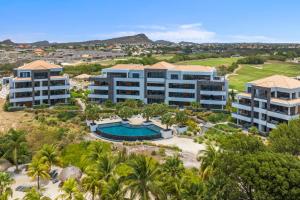 an aerial view of a resort with a swimming pool at The Shore 2 luxury beach front condo in Willemstad
