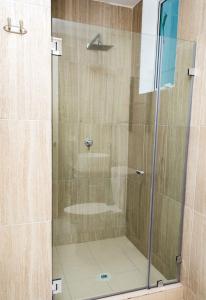 a shower with a glass door in a bathroom at 3A - 4BR Apartment ! in Panama City