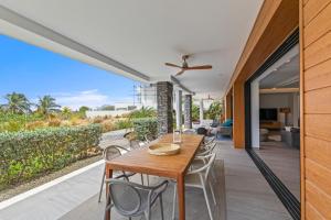 an outdoor dining area with a wooden table and chairs at The Shore 2 luxury beach front condo in Willemstad