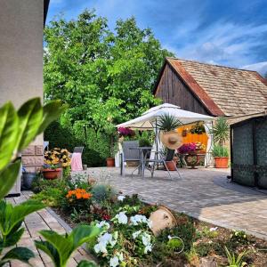 a garden with a table and chairs and a barn at Vila Harmónia in Turčianske Teplice