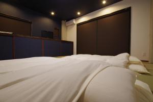 Postel nebo postele na pokoji v ubytování Cinnamon Guesthouse Dogo
