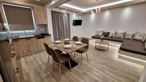 a living room with a table and a couch at Alta Vista Apartments in Agkidia