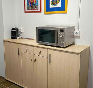 a microwave sitting on top of a wooden cabinet at Ferienhaus WYSS in Wolfach