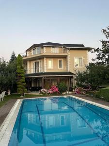 a large house with a swimming pool in front of it at Villa Elegance in Kocaeli