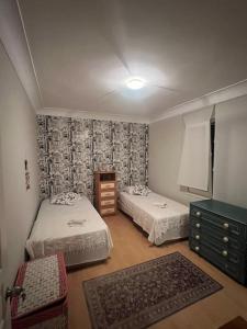 a small room with two beds and a dresser at Villa Elegance in Kocaeli +81 photos