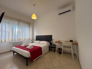 a bedroom with a bed and a table and a desk at Peppe's Bed in Rome