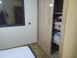 a bathroom with a walk in closet with towels at Appartement familial 2 in Oualidia +2 photos