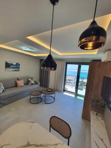 a living room with a couch and a table at Sealon Suite & Loft in Limenaria