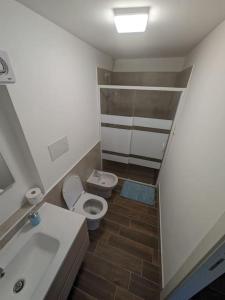 a small bathroom with a toilet and a sink at Il Ruderino in Melito di Porto Salvo