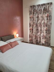 a bedroom with two beds and a curtain at Guest house Romana Vecchia in Monticchio