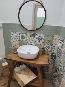 a bathroom with a sink and a mirror on a table at Guest house Romana Vecchia in Monticchio +39 photos
