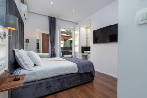 a bedroom with a large bed and a tv at Antares Luxury Rooms 1 in Split