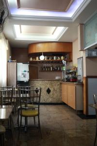 a kitchen with tables and chairs in a restaurant at Hotel Mooca in São Paulo