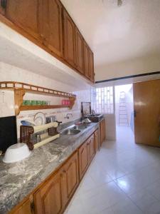 a kitchen with a sink and a counter top at Appartement moderne avec wifi gratuit et parking privé à salé in Sale