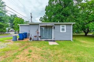 a small gray house with a door in a yard at Family-Friendly 2BR Cottage Near Creve Coeur Lake in Maryland Heights