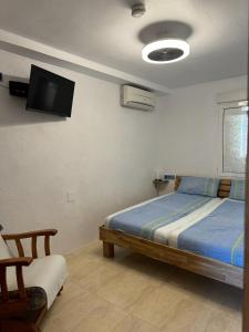 a bedroom with a bed and a tv on the wall at Torrevieja - LaMata - Sonny in La Mata +26 photos
