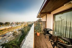 a balcony with a table and a view of a city at Edahan Hotel in Biga
