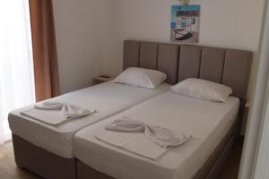a bedroom with two beds with towels on them at Captain's View in Dobra Voda