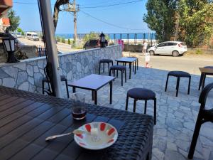 a table with a plate of food and chairs on a patio at MUKKA TURIZIM AMAÇLI Daireler in Pelitli