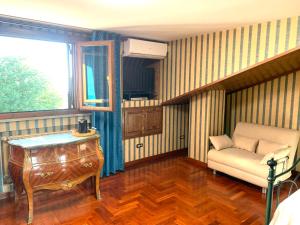 a living room with a couch and a table at Maison Martina in Ariccia
