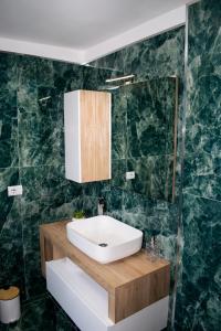 a bathroom with a sink and a mirror at Maison Martina in Ariccia +32 photos