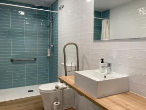 a bathroom with a sink and a toilet and a shower at Dormavalencia Crónica in Valencia +52 photos