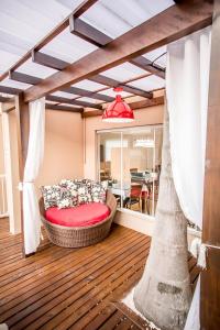 a living room with a couch on a wooden floor at Pousada Portal do Sol Bombinhas in Bombinhas