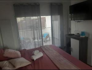a bedroom with a bed with two towels on it at Love Room Séduction in Tremblay-En-France