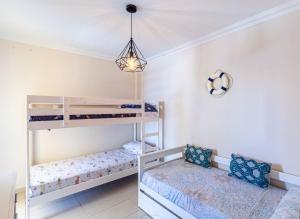 A bed or beds in a room at La Perla Playa Apt Dream Homes Tenerife