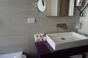 a bathroom with a sink and a mirror at Trevi Palace Luxury Inn in Rome