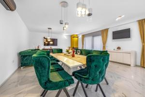a living room with green velvet chairs and a table at Pool House Fancy - Happy Rentals in Labin +26 photos