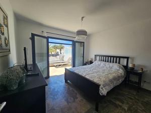 a bedroom with a bed and a desk with a computer at Luna Azul in Playa Blanca +31 photos