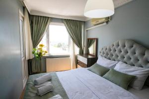 a bedroom with a large bed with a large window at 3 Diffrent Family Apartments At Center Walking 5 Minutes in Istanbul