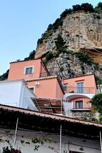 a pink building on top of a mountain at Sosò Art b&b in Positano