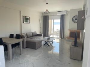 a living room with a couch and a table at Eagle View Karystos in Karistos